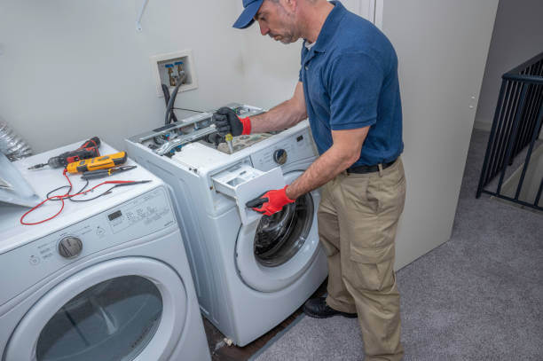 Washing machine repair technician at work